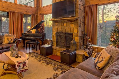 a living room with a fireplace and a piano at Soaring Eagle in Sautee Nacoochee