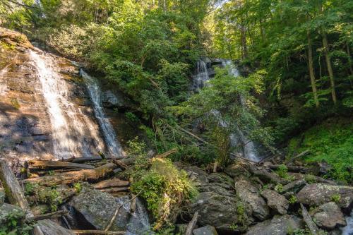 a waterfall in the middle of a forest at Serenity in Sautee Nacoochee