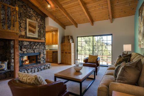 a living room with a couch and a fireplace at Leslie Creek House in Mark West Springs