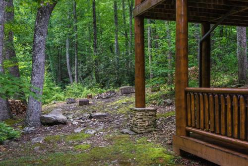 a porch of a cabin in the woods at Chief Big Log Cabin in Hatchertown