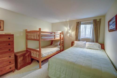 a bedroom with a bunk bed next to a window at Okemo Trailside 08E in Ludlow