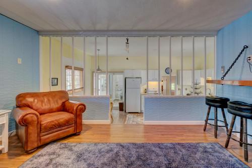 a living room with a chair and a kitchen at Plum Island Prize in Newburyport