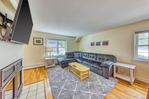 a living room with a couch and a table at Cozy Stowe Retreat in Stowe