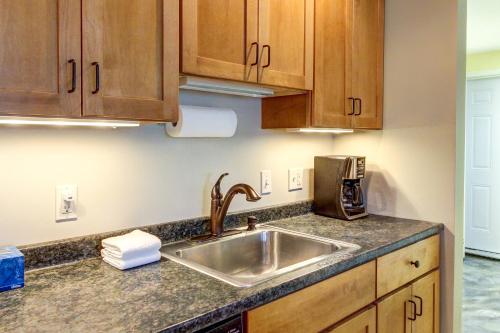 a kitchen with a sink and wooden cabinets at Alpine Drive Adventure in Telemark Village