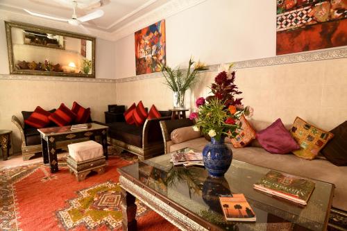 a living room with a couch and a table at Riad Shaden in Marrakech