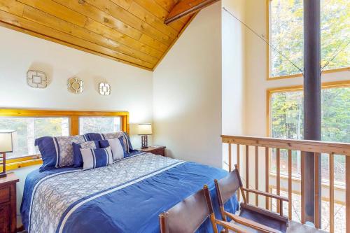 a bedroom with a bed and a balcony at Bob's Bungalow in North Sherburne