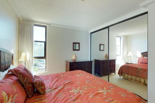 a bedroom with two beds and a large mirror at Maui Kai 507 & 508 in Honokowai