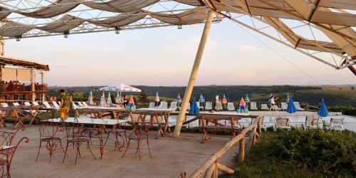 a group of tables and chairs under a tent at Seven Generations Winery Hotel in Mechka