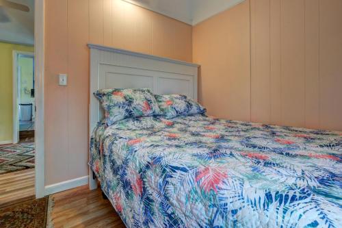 a bedroom with a bed with a colorful comforter at Plum Island Prize in Newburyport