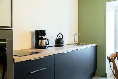 a kitchen with a counter top with a coffee maker on it at Ker Iliz in Bédée