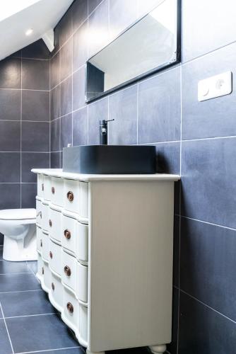 a bathroom with a sink and a mirror at Ker Iliz in Bédée