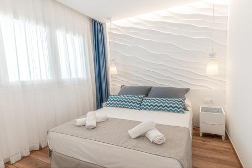a bedroom with a bed with a wave mural on the wall at Alcossebre Sea Experience in Alcossebre