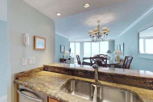 a kitchen with a sink and a dining room at Anna Maria Island Club Unit17S in Holmes Beach
