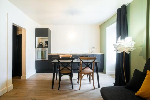 a kitchen and living room with a table and chairs at Ker Iliz in Bédée