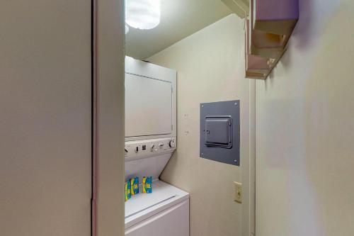 a small bathroom with a washer and dryer at Lodge 3007 in Pagosa Springs