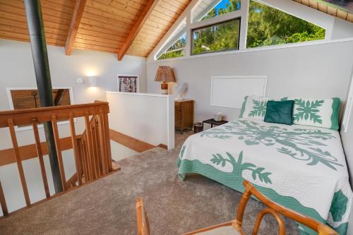 a bedroom with a bed and two windows at Kalaheo View - TVNC 5018 in Kalaheo
