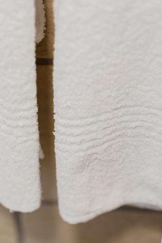 a stack of white paper towels on a table at Nguni River Apartment in Plettenberg Bay