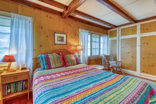 a bedroom with a large bed in a room with wooden walls at Longs Peak Cabin in Estes Park