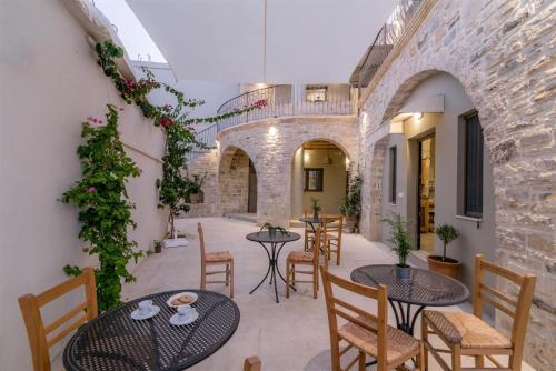 a patio with tables and chairs in a building at Mokamvilia in Petrokefálion