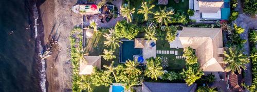 an overhead view of a house with palm trees at Villa Cantik in Lovina