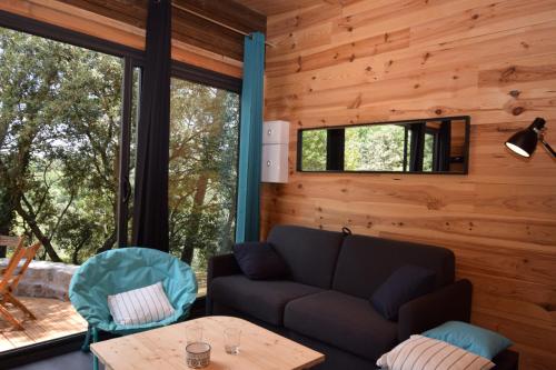 a living room with a couch and a table at L'ERIC-Gites de tit'âne in Gignac
