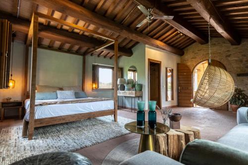 a bedroom with a bed and a couch at Borgo Castello Panicaglia in Nocera Umbra