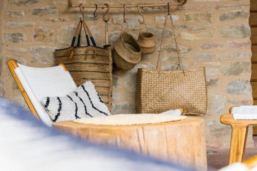 a room with a chair and baskets on a wall at Borgo Castello Panicaglia in Nocera Umbra