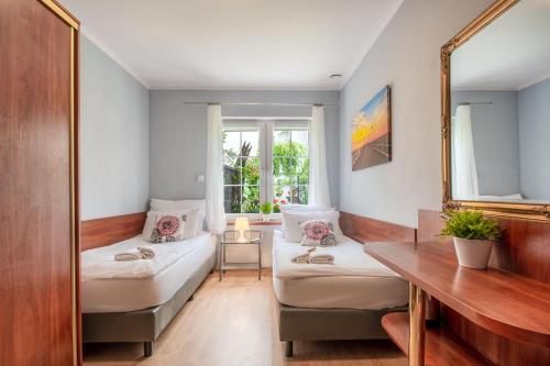 a room with two beds and a mirror at Plac Rybaków Inn in Sopot