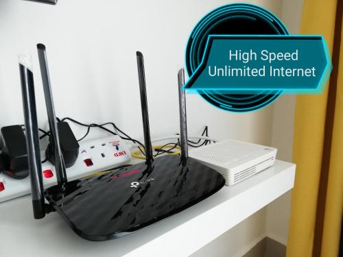 a router sitting on top of a shelf at Ara Damansara Oasis Residence, Specious Home 4-8pax, 8min Subang Airport, 10min Sunway in Petaling Jaya