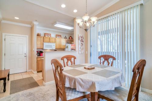 a kitchen and dining room with a table and chairs at Pristine Top Floor Condo With Access To Clubhouse & Pools in Phoenix