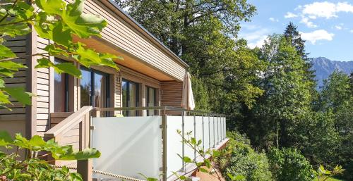 una casa con una valla blanca y árboles en Ferienbungalow Mountain View Wood, en Spital am Pyhrn