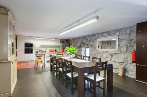 a kitchen and dining room with a table and chairs at Host Wise - Boutique Country House w Pool in Travanca