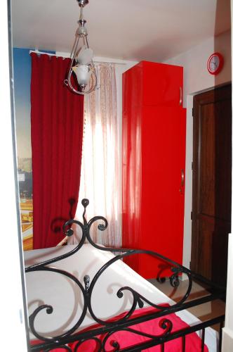 a bedroom with a red dresser and a bed at Apartment "Ceazars" in K'obulet'i