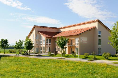 a rendering of a building with a lawn at Hotel Inspiration Garni in Tittmoning
