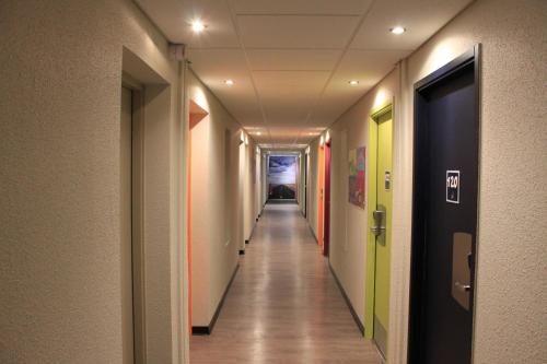 a corridor of an office building with a long hallway at ibis budget Metz Technopole in Metz
