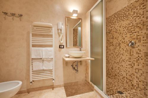 a bathroom with a sink and a toilet and a shower at B&B Le Stanze del Duomo in Florence