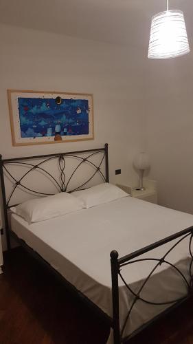 a bedroom with a bed with a black frame at Villetta G in Senigallia