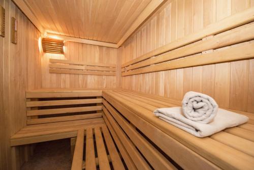 a wooden sauna with a towel sitting in it at "Bootsschuppen" by Ferienhaus Strandgut in Born