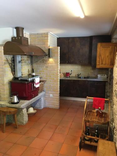 a kitchen with a red stove in a kitchen at Casa Real in Barcelos