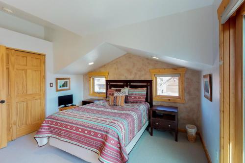 a bedroom with a large bed and a window at Coyote Run 12 in Moab