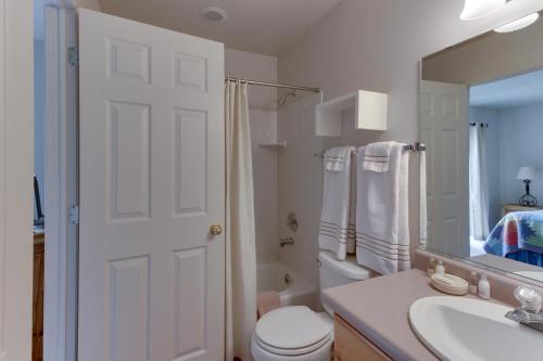 a bathroom with a toilet and a sink and a mirror at Solano Vallejo 3329 in Moab