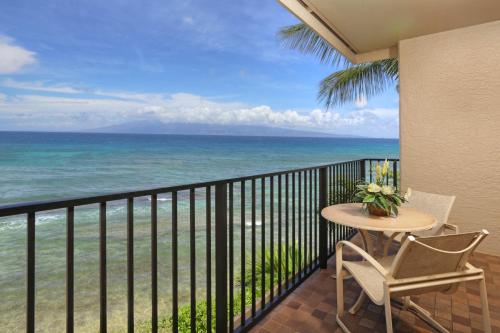a balcony with a table and chairs and the ocean at Kaanapali Shores 361 in Kaanapali