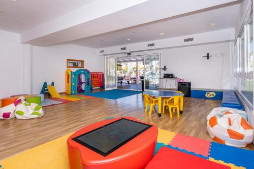 a play room with a table and chairs at Comitas Isla del Aire in Punta Prima