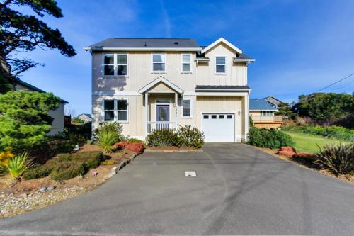a large white house with a driveway at The Yellow Rose House in Lincoln City