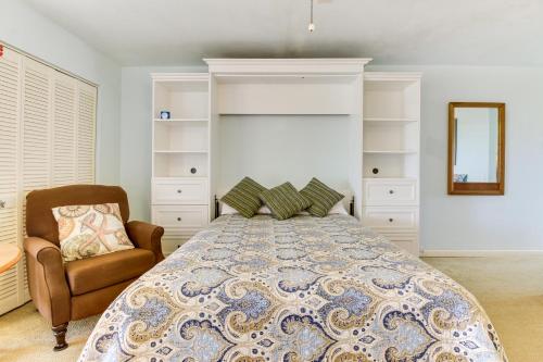 a bedroom with a bed and a chair and a mirror at Marina Retreat in South Padre Island