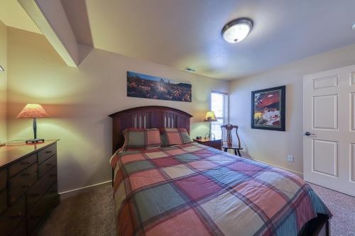 a bedroom with a bed and a dresser and a door at Rim Village O3 in Moab
