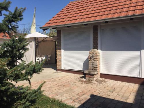 a house with two garage doors on a patio at Vila Sunce Morovic in Morović