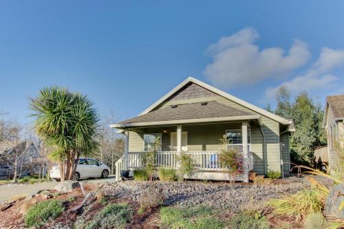 a house with a palm tree and a car at Cedar Creek Retreat in Rockaway Beach