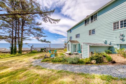 a blue house with a yard next to it at Hale Kaalawai Unit B in Oceanside