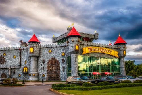 a building with cars parked in front of it at Bear Hugs in Pigeon Forge